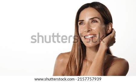 Anti-aging skin lifting beauty. Smiling adult woman in her mid 40s, has hyaluronic acid skin care treatment, smooth nourished face, standing over white background Royalty-Free Stock Photo #2157757939