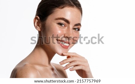 Women beauty and spa. Beautiful smiling brunette with thick eyebrows, white healthy smile, glowing shoulders and face, no blemishes or pimples, cleansing gel after effect