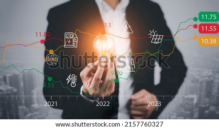 Businessman hand hold light bulb with tablet concept and Stock market or forex trading graph and candlestick chart suitable for financial investment money, currency exchange,Technology and Big Data