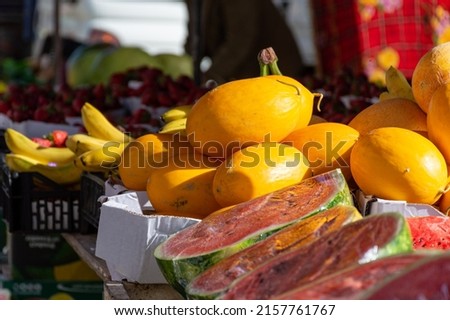 Watermelon and canary yellow melons in the market. Summer fruits.