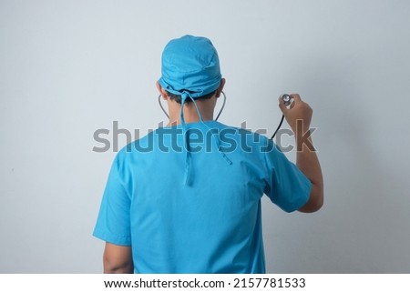 rear view of male nurse holding stethoscope