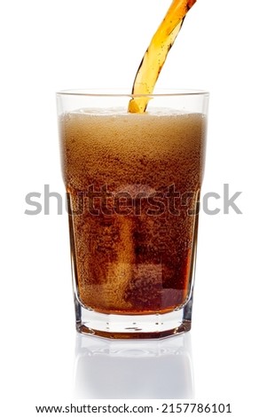 Carbonated drink pour into glass on white background