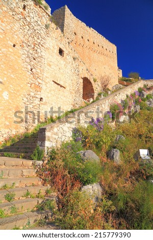 Sunny stairs and spring flowers ascending to Palamidi Castle near Nafplio, Greece