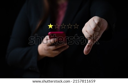 Business women select bad face emoticon on virtual touch screen at smartphone. Bad review, bad service dislike bad quality, low rating, social media not good Royalty-Free Stock Photo #2157811659