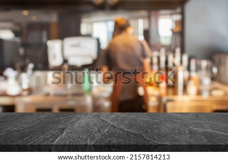 Empty marble table top with coffee shop cafe restaurant counter blur background