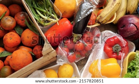 Food Waste. Fruits and vegetables are wasted by suppliers, retailers, and consumers. Throwing out food that cant be sold. Discarded unsold damaged fruits and vegetables in packages Royalty-Free Stock Photo #2157820851