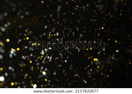Macro shot of wet makeup glitter on black surface