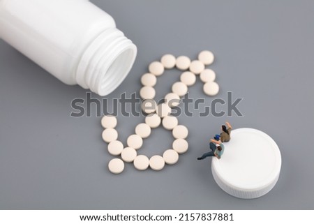 Miniature creative talking about drug price pills dollar sign