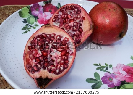 Freshly cut broken Pomegranate red colour fruit with seeds inside