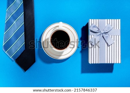 Father day greeting card background. Fathers day concept with gift box, tools and ties, coffee cup, gift tag  Love you dad, on brightblue background top view copy space