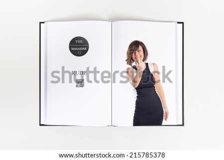 Pretty woman making horn gesture printed on book