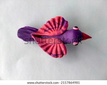 colorful plasticine clay birds isolated on white background.Handmade modelling clay sculpture made with play dough.plasticine world.