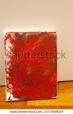 This orange and red abstract art painting is done on canvas and oil colors were used. 