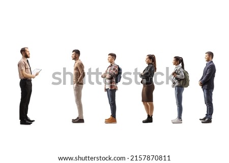 Full length profile shot of a security officer standing in front of people waiting in line isolated on white background Royalty-Free Stock Photo #2157870811
