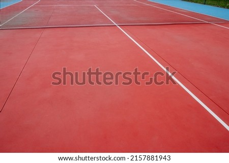 View of a red hard-surface tennis court
