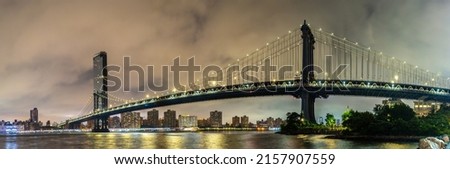 Panorama of  Manhattan Bridge and panoramic night view of downtown Manhattan after sunset in New York City, USA