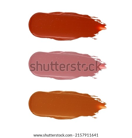 Cosmetics lipstick swatches. Creamy matte textured lip smear on isolated background. Macro red color smudge with texture.
