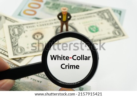 White-Collar Crime.Magnifying glass showing the words.Background of banknotes and coins.basic concepts of finance.Business theme.Financial terms. Royalty-Free Stock Photo #2157915421