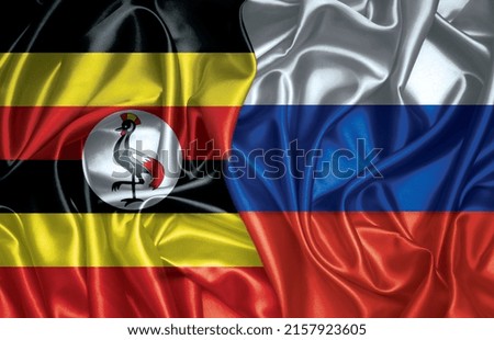 Uganda and Russia two folded silk flags together