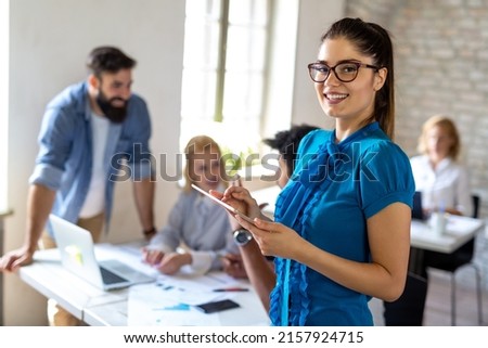 Working on new project together. Group of happy business people cooperating as a team in office Royalty-Free Stock Photo #2157924715