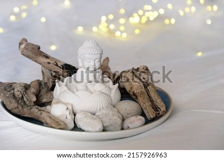 	
little Buddha and minerals, natural decor on plate, abstract blurred background. Magic altar for healing esoteric spiritual practice, relaxation, meditation, soul harmony. life balance, spa concept