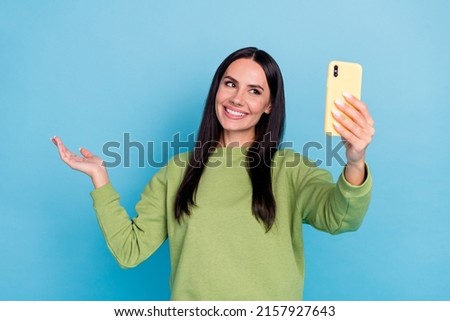 Portrait of cheerful lady make selfie arms palm hold demonstrate empty space isolated on blue color background