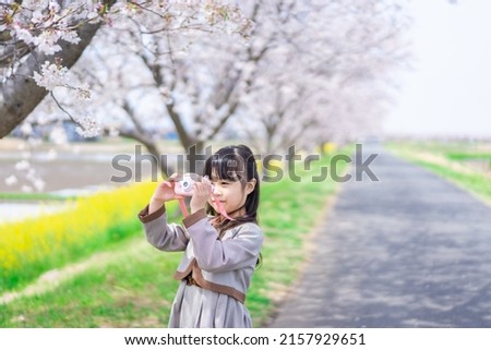 Elementary school students taking pictures with a camera