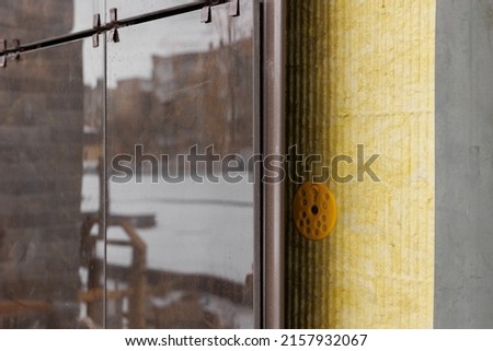 The system of fixing the facade on the building. Aluminum decorative profiles on the building. Modern architectural solutions. Ventilated facade with stone wool insulation and ceramic tiles Royalty-Free Stock Photo #2157932067