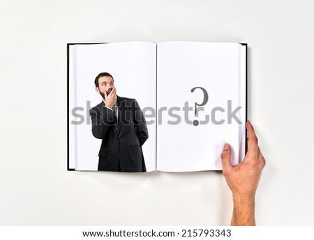 Businessman surprised printed on book