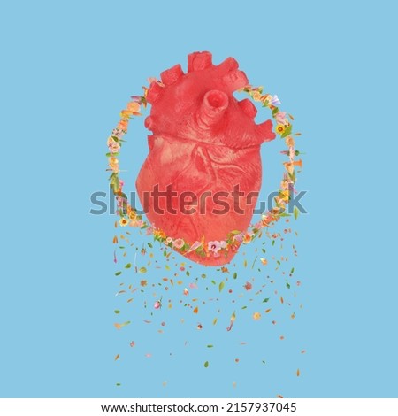 Abstract organic organ human heart in ring made of lot of flowers falling down. Love emotional wounded heart concept. Floral heart idea