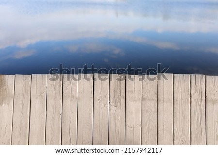 Wooden pier on lake background Royalty-Free Stock Photo #2157942117