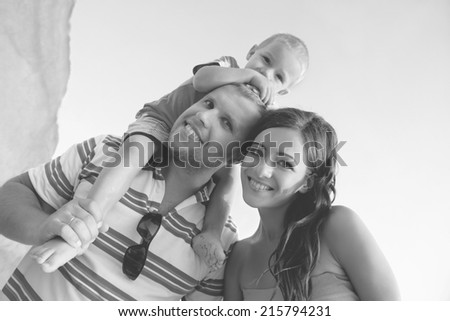 Happy young family having fun outdoors in summer. Black and white photo 