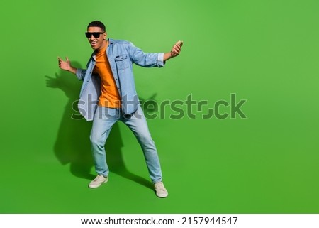 Full body image of good mood young man have fun relaxing on weekend in nightclub isolated on green color background Royalty-Free Stock Photo #2157944547