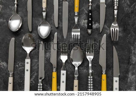 Many different cutlery on grunge background, top view