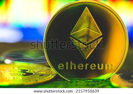 World cryptocurrency. Ethereum coin in yellow-green neon light close-up. Financial system of the future