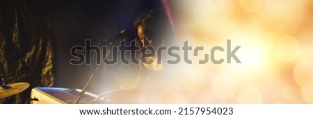 Blurred effect with copy space against mid section of african american female artist playing piano. music festival and concert concept