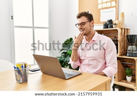 Young hispanic man having video call communicating with deaf sign language at office