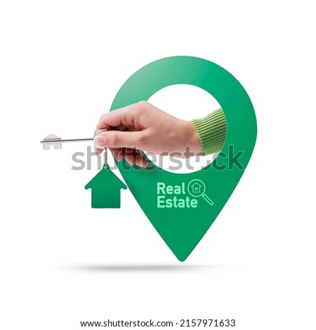 Hand holding house keys and location pin, real estate concept, White background Royalty-Free Stock Photo #2157971633