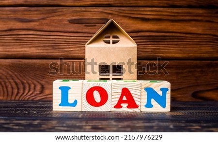 Wooden home and text on the cubes loan
