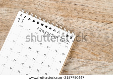 The November 2022 desk calendar on wooden background.