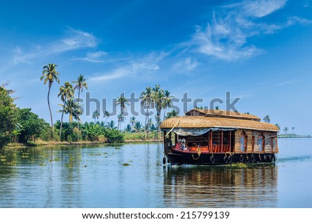Travel tourism Kerala background - houseboat on Kerala backwaters. Kerala, India Royalty-Free Stock Photo #215799139