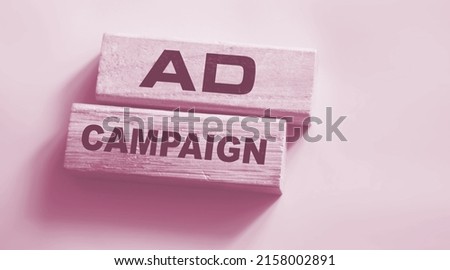 Ad Campaign on Wooden Blocks on gray background. Marketing advertising business Concept.