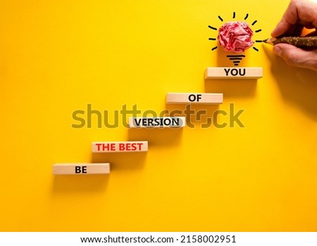 Best version of you symbol. Wooden blocks with words Be the best version of you on beautiful yellow background, copy space. Businessman hand, light bulb icon. Business, best version of you concept. Royalty-Free Stock Photo #2158002951