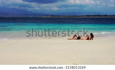 A photo of a beautiful Russian couple resting in Gili Meno, Lombok, Indonesia, Asia