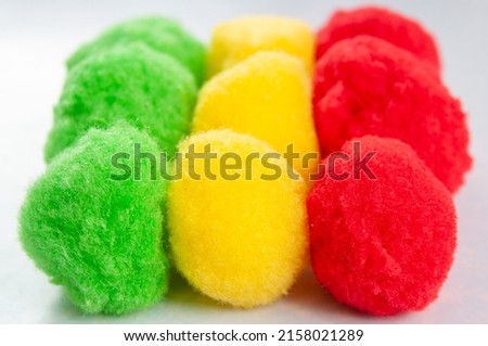 fluffy balls of green, yellow and red