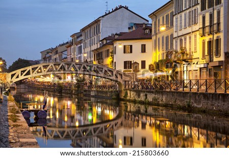 Bridge across the Naviglio Grande canal at the evening in Milan, Italy Royalty-Free Stock Photo #215803660