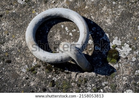 a photo of metal ring in rock