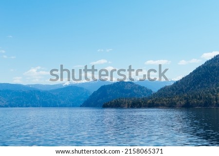Minimal mountains and lake landscape. Altai Republic, Lake Teletskoye. Travel destinations.
