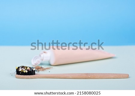 ecological tooth wooden brush and paste on a blue background. concept glamor smile shine, mouth and teeth health
