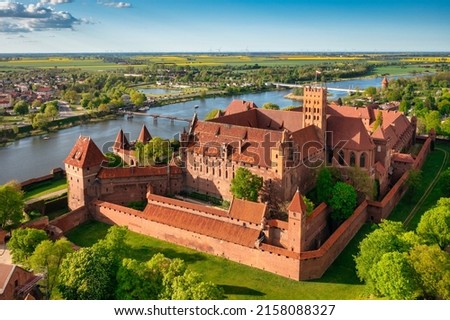 The Castle of the Teutonic Order in Malbork by the Nogat river. Poland Royalty-Free Stock Photo #2158088327